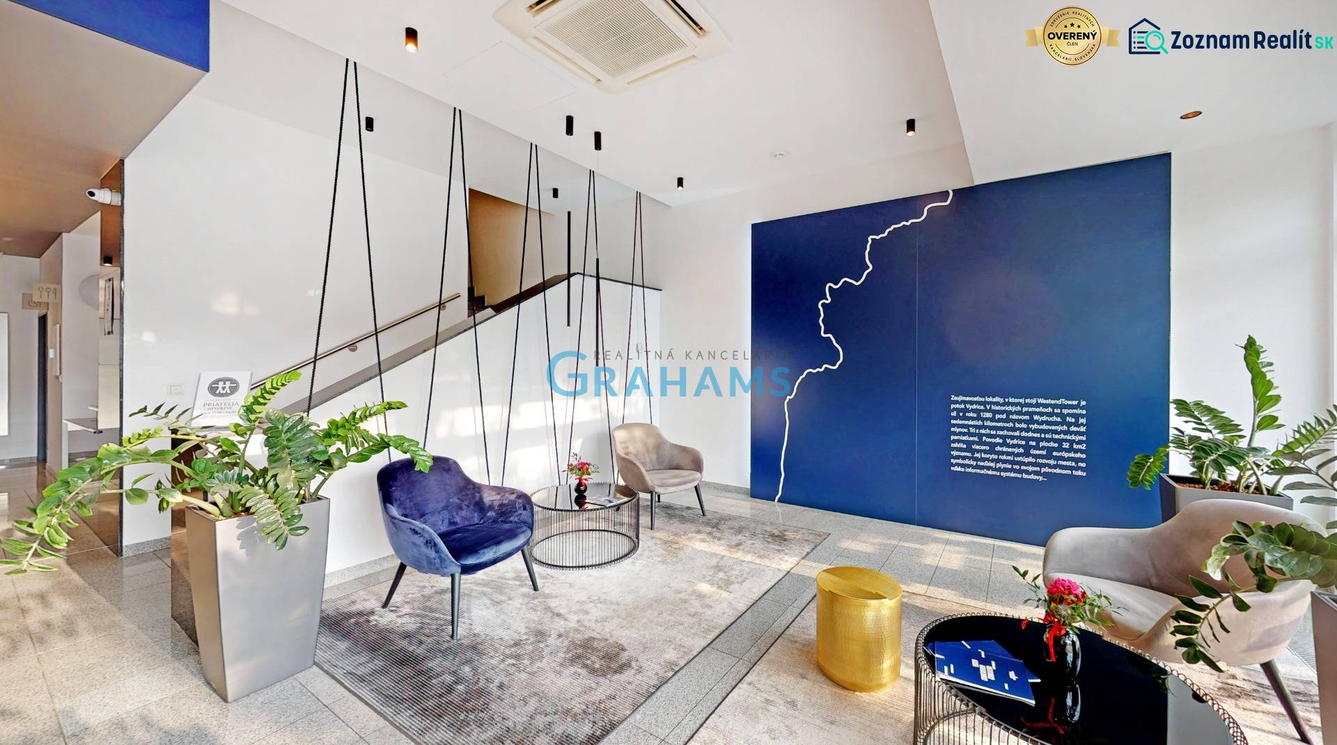 3D, prenájom kanc. Flexi od 14,4 m2, Westend Tower, Dúbravská cesta - Priestor kancelárie s rastlinami, kreslami, modrou stenou a visiacou dekoráciou.