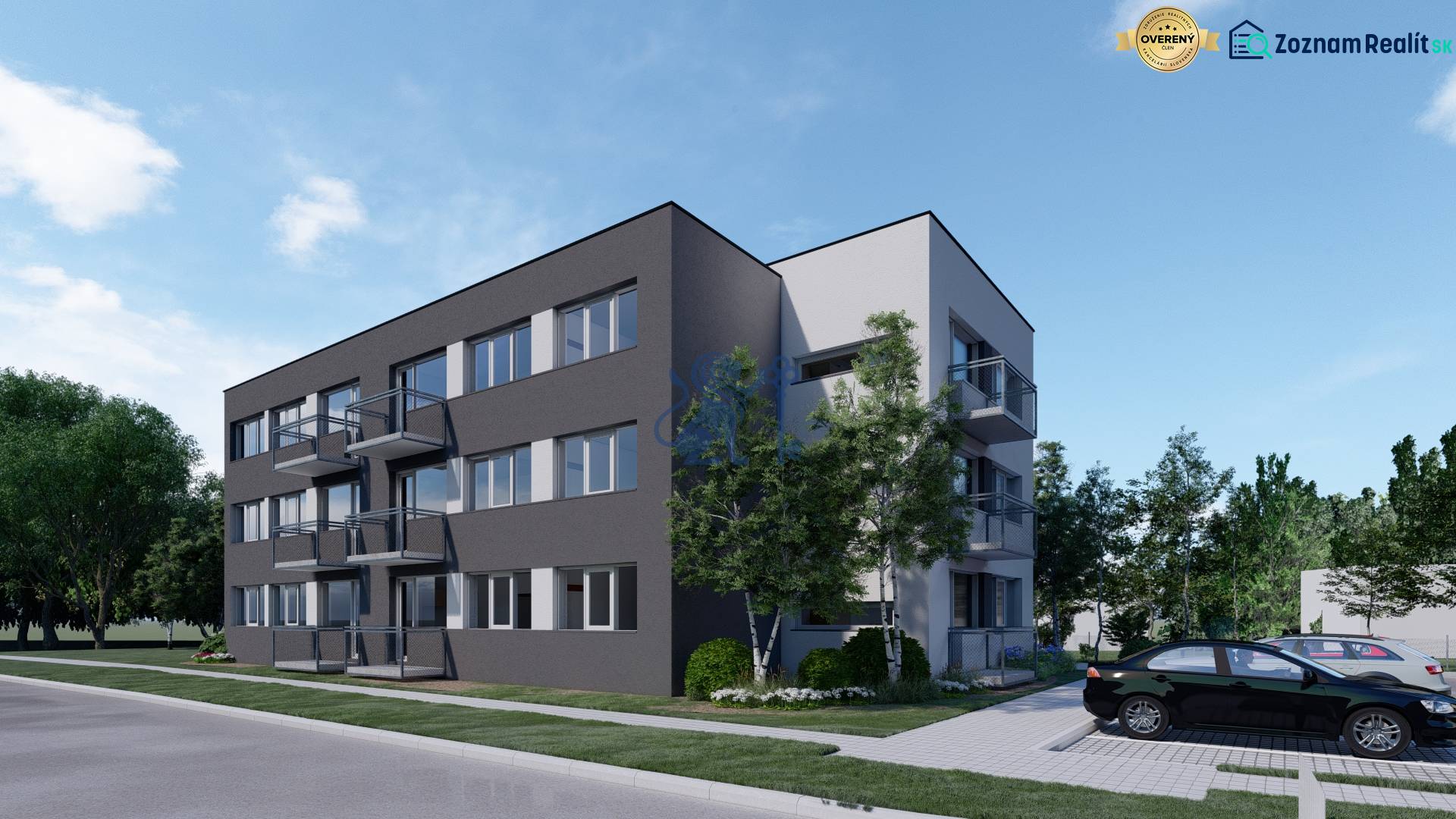 Pozemok s rozostavanou stavbou pre 12 bytov pri Senici - Bytový komplex s parkovacími miestami, obklopený zeleňou a výhľadom na developerské pozemky.