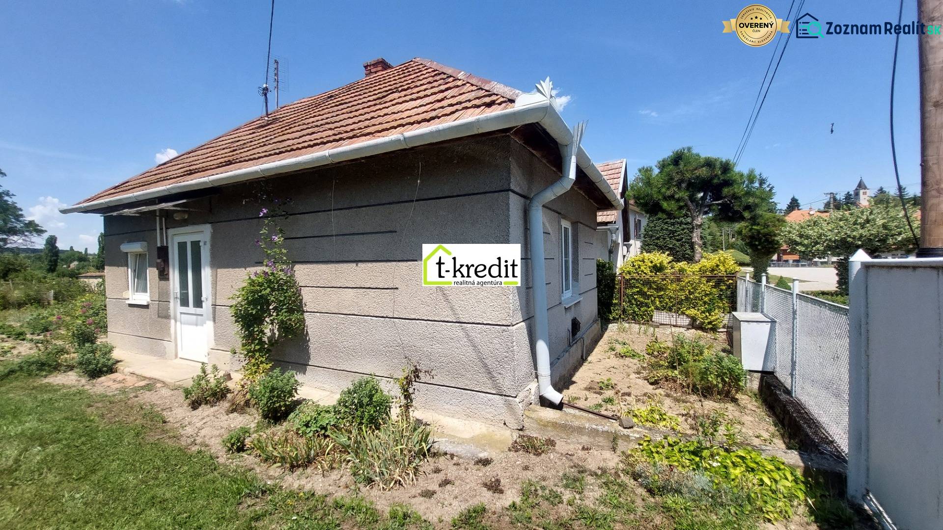 PREDAJ - ÚTULNÝ DOMČEK NA ROZĽAHLOM POZEMKU - NEVIDZANY - Rodinný dom v Nevidzanoch s upravenou záhradou, oplotením a šikmou strechou.