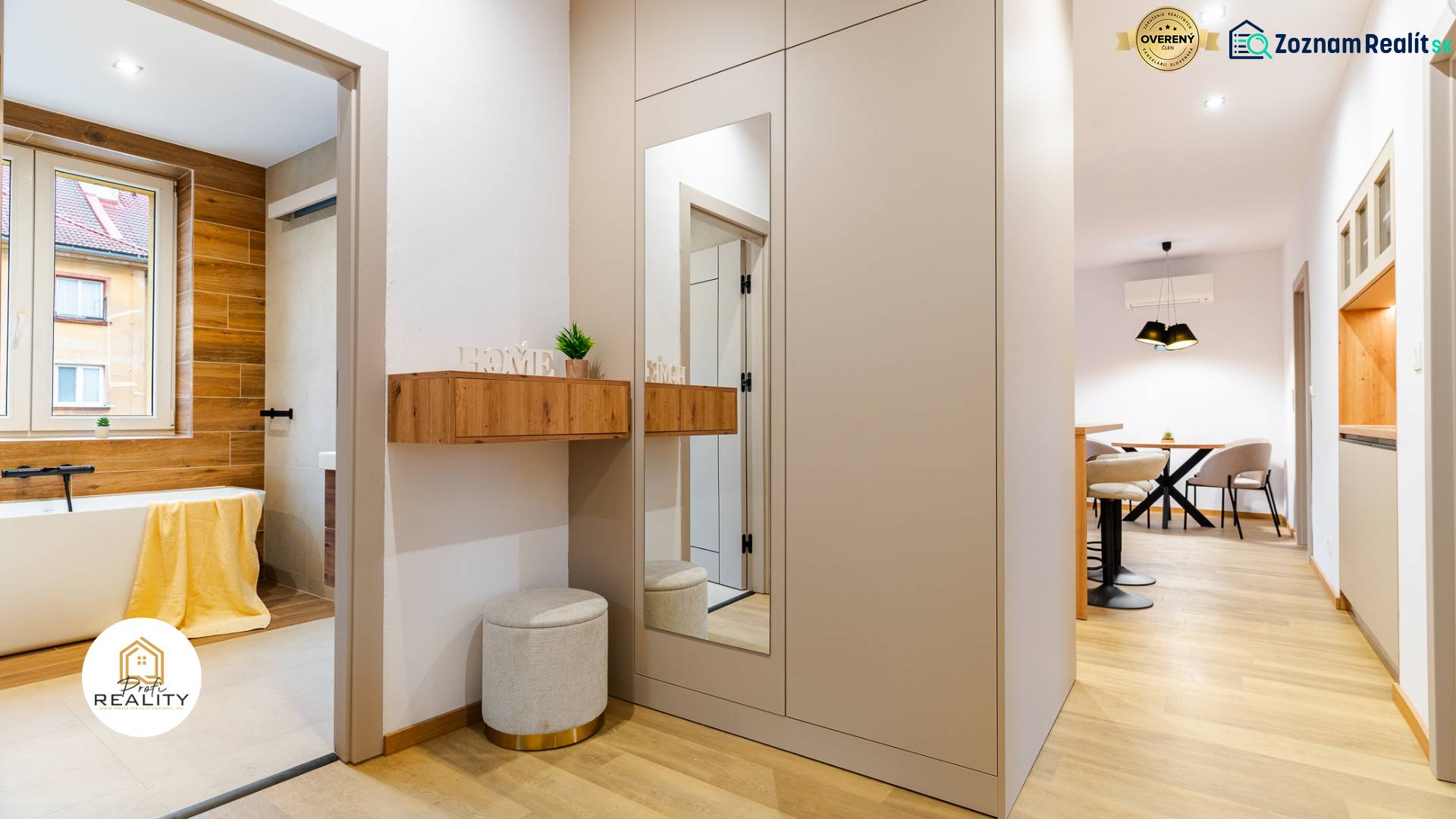 PREDAJ | 3i tehlový BYT, 90 m², centrum PO, balkón , Klimatizácia ... - Interiér 3-izbového bytu s kúpeľňou a kuchynským kútom, podlaha s dreveným dekorom.