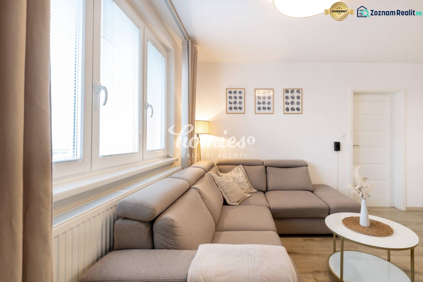 PREDAJ 2 izbový moderne zrekonštruovaný byt s klimatizáciou, CENTRUM - Obývacia izba v 2-izbovom byte s pohodlnou sedačkou a dekoráciami na stene.