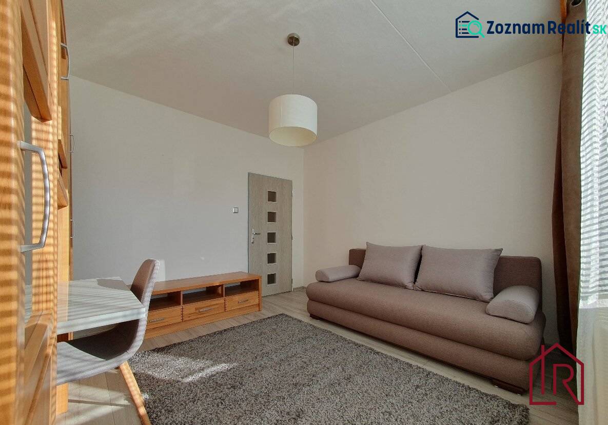 KH-1052, 3 izbový byt, Košice – Staré Mesto, širšie centrum, Kuzmányho - Obývačka v 3-izbovom byte s pohovkou, koberec a podlaha s dreveným dekorom.