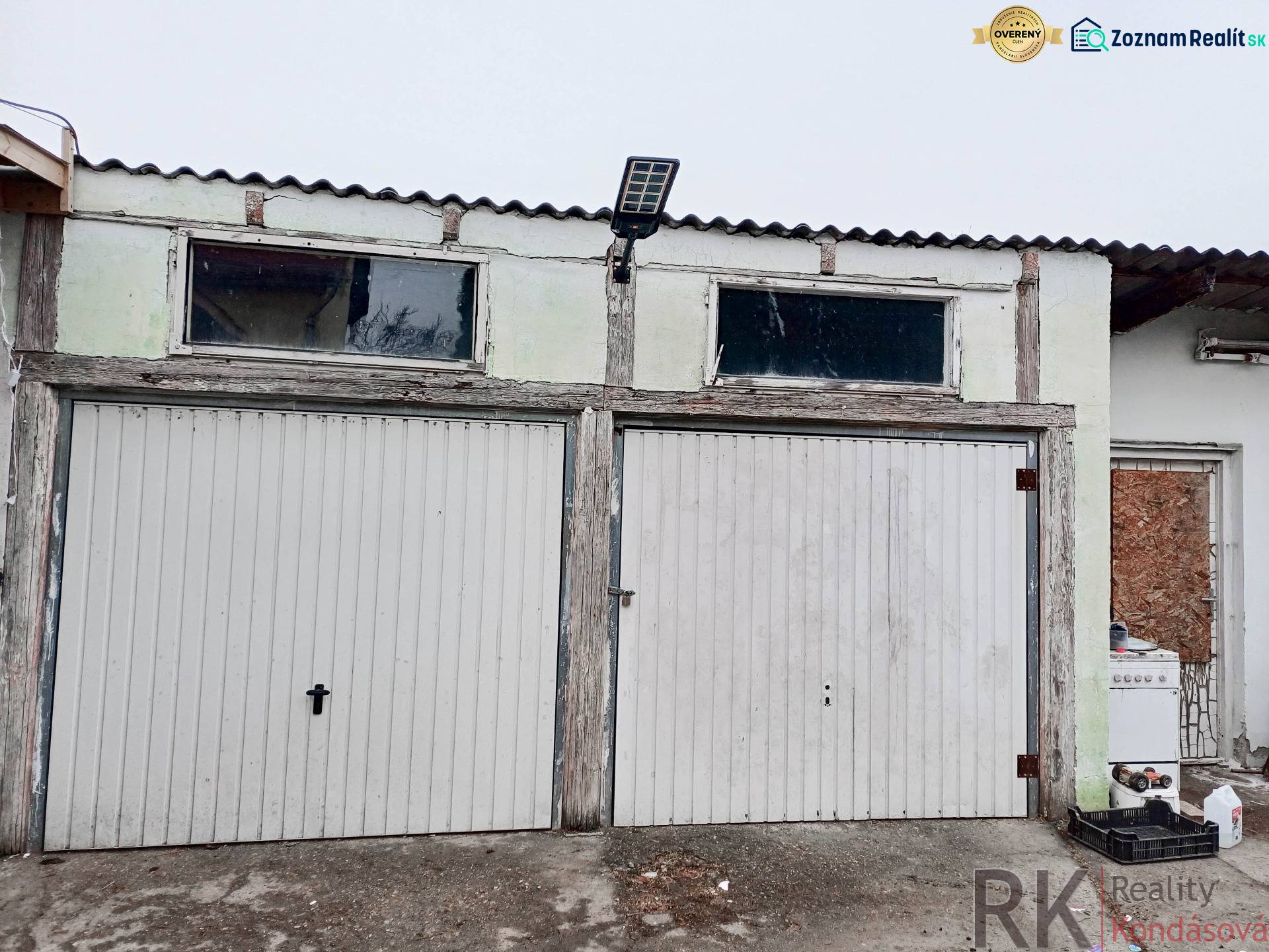 Rodinný dom, Maďarsko, obec Vizsoly - Garáž s dvoma roletovými dverami a solárnym panelom pri rodinnom dome v Vizsoly.