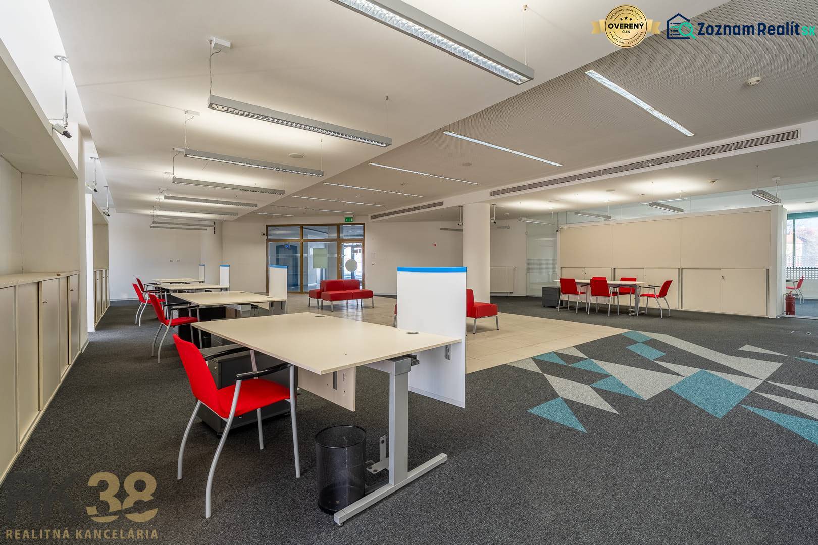 Reprezentatívne administratívne priestory na prenájom  - Interiér kancelárií s červenými stoličkami a kobercovým dekorom na podlahe.
