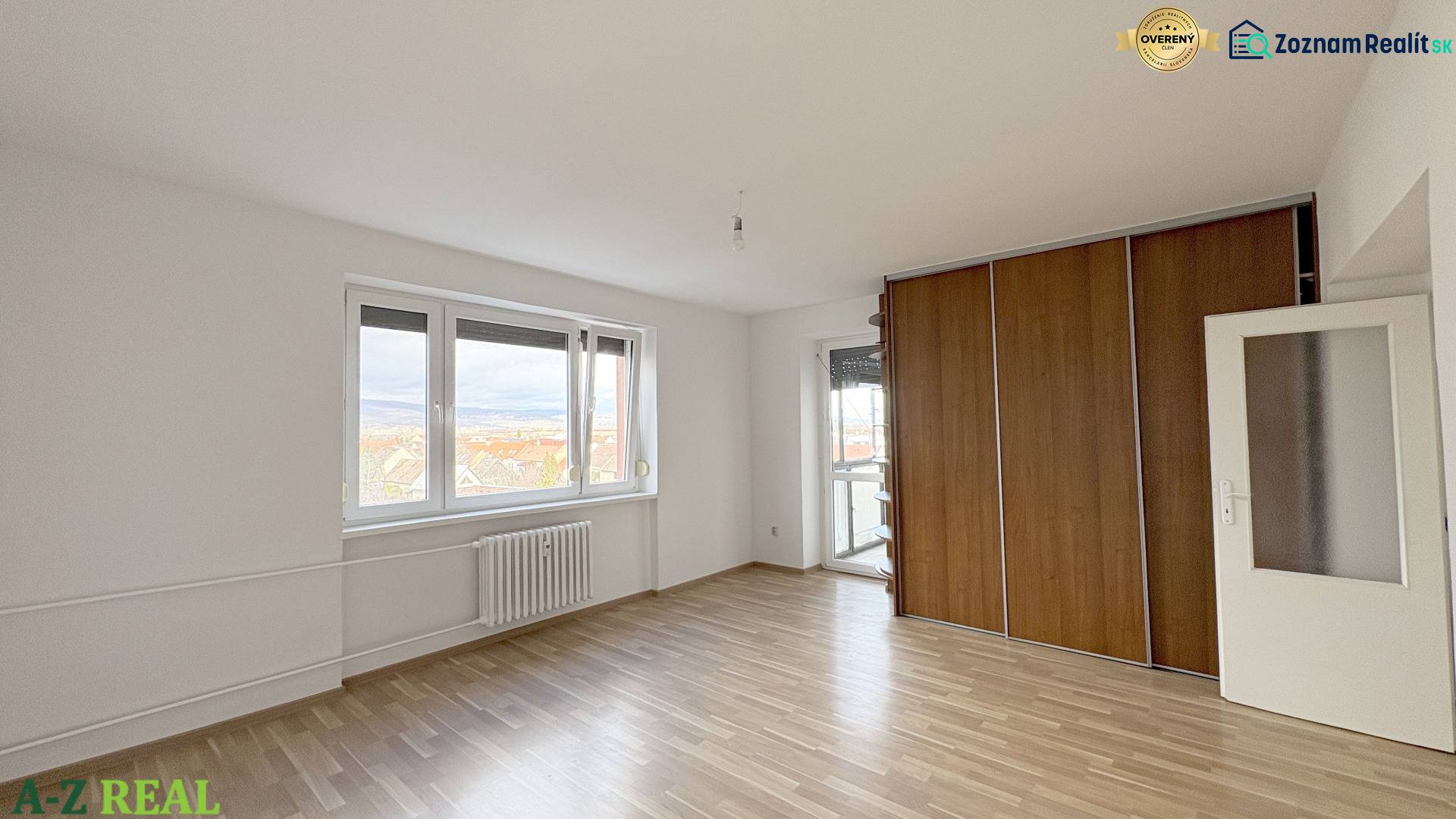 Exkluzívne predáme pekný 3-izbový byt vo Vajnoroch - Izba s podlahou s dreveným dekorom, vstavanou skriňou a oknom v 3-izbovom byte.