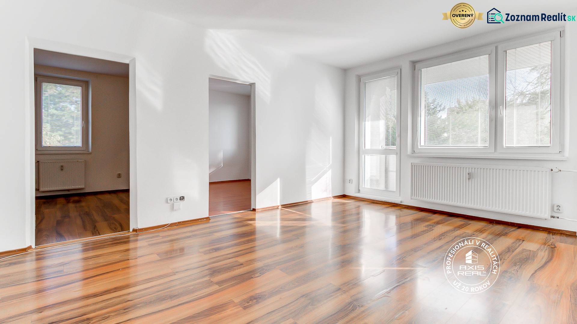  NEZARIADENÝ 3-izb.byt, 11m2 LODŽIA, BA IV., Červeňákova - Svetlý obývací priestor v 3-izbovom byte s podlahou s dreveným dekorom a veľkými oknami.