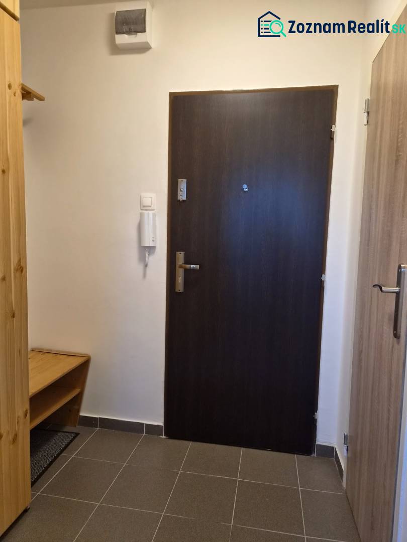 REZERVOVANÉ! Zariadená garsónka po kompletnej rekonštrukcii - Vstupná chodba Rekreačného apartmánu s tmavými dverami a dlažbou.
