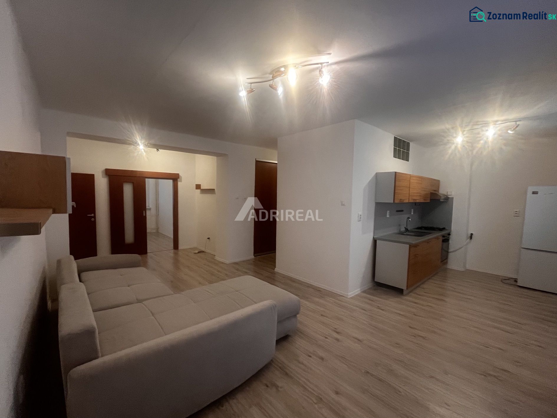 PREDAJ: 3i s balk. 67 m2; Uhlisko-Banská Bystrica; 205.000 € - Obývacia izba v 3-izbovom byte s kuchyňou a podlahou s dreveným dekorom.