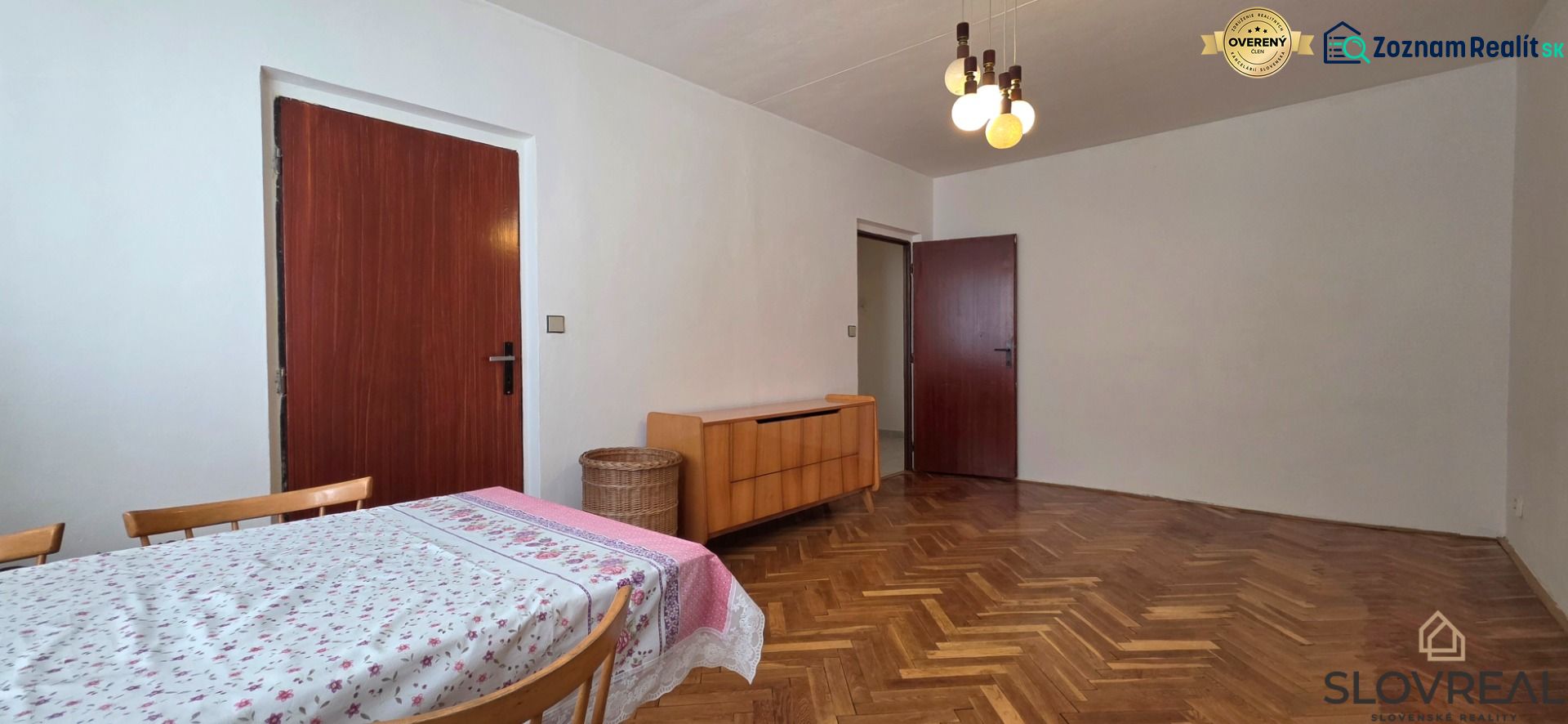 Na predaj 2 izbový byt Zvolen, 64 m2 - Jedáleň v 2-izbovom byte s podlahou s dreveným dekorom a jednoduchým zariadením.