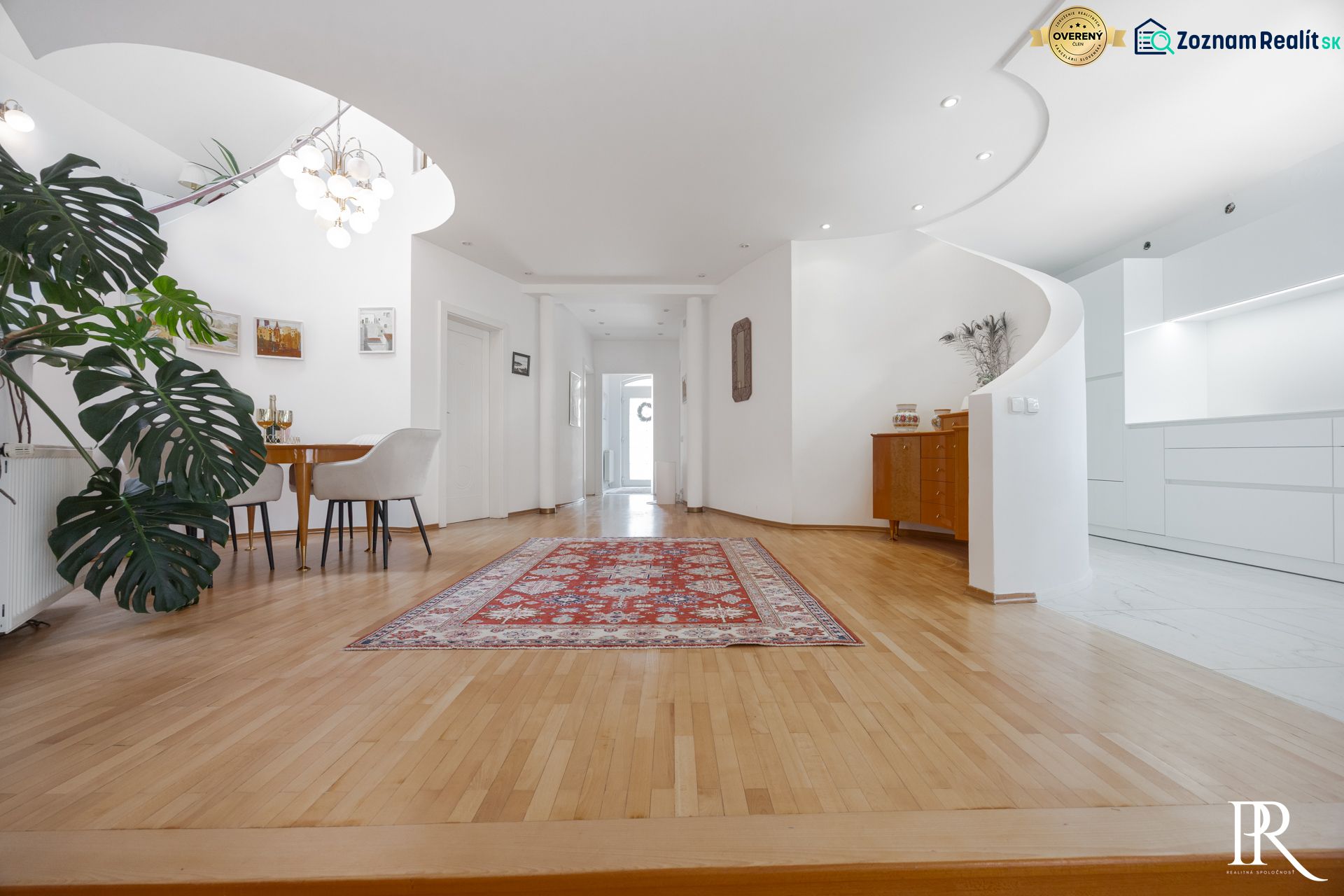 Rezidenčná vila v širšom centre Piešťan - Interiér rodinného domu s jedálenským kútom, podlahou s dreveným dekorom a orientálnym kobercom.