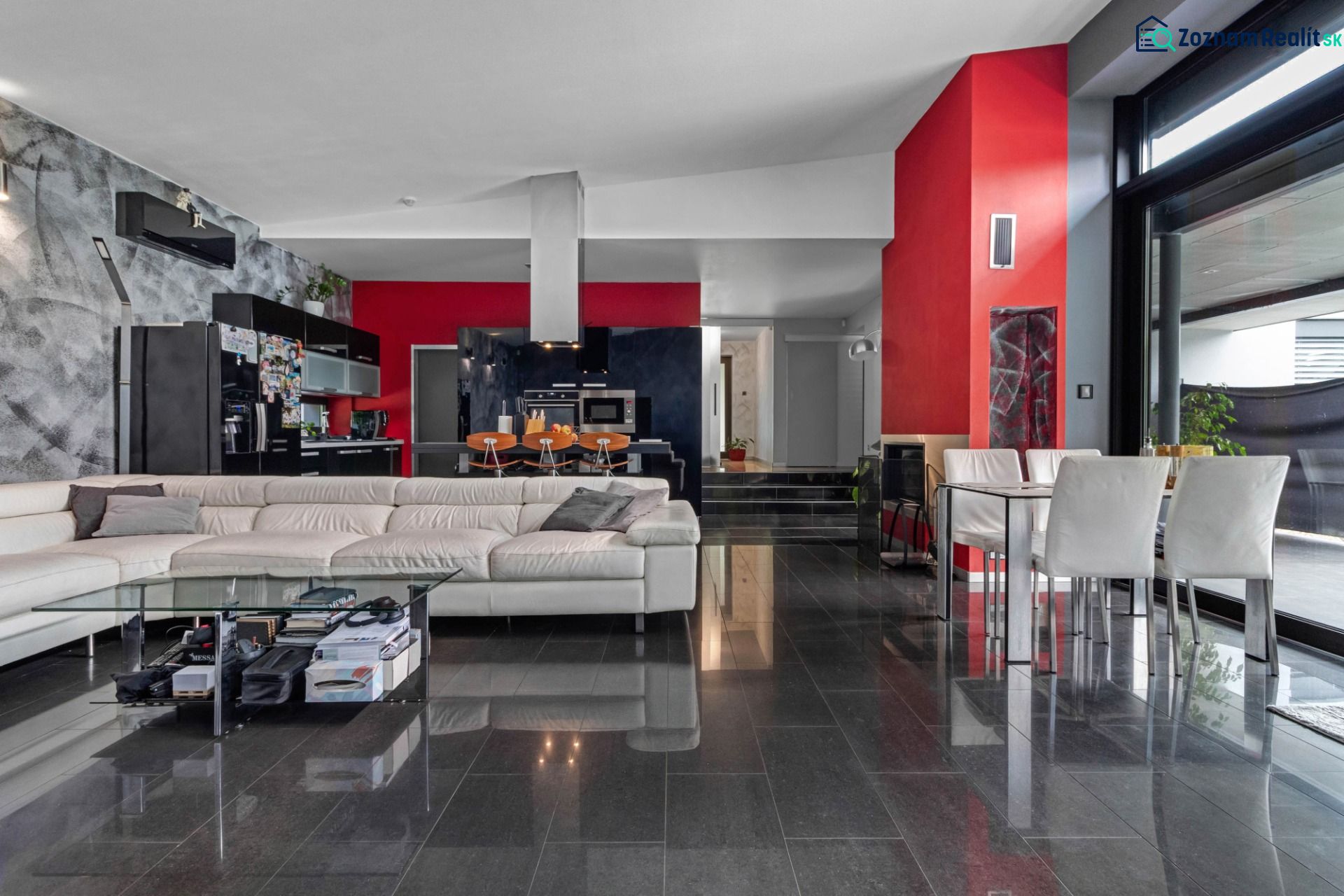 ARCHITEKTÚRA TICHA A MODERNÝCH TECHNOLÓGIÍ - SMART VILLA V OBJATÍ LESA - Otvorený priestor v rodinnom dome s bielou sedacou súpravou a presklenou stenou.