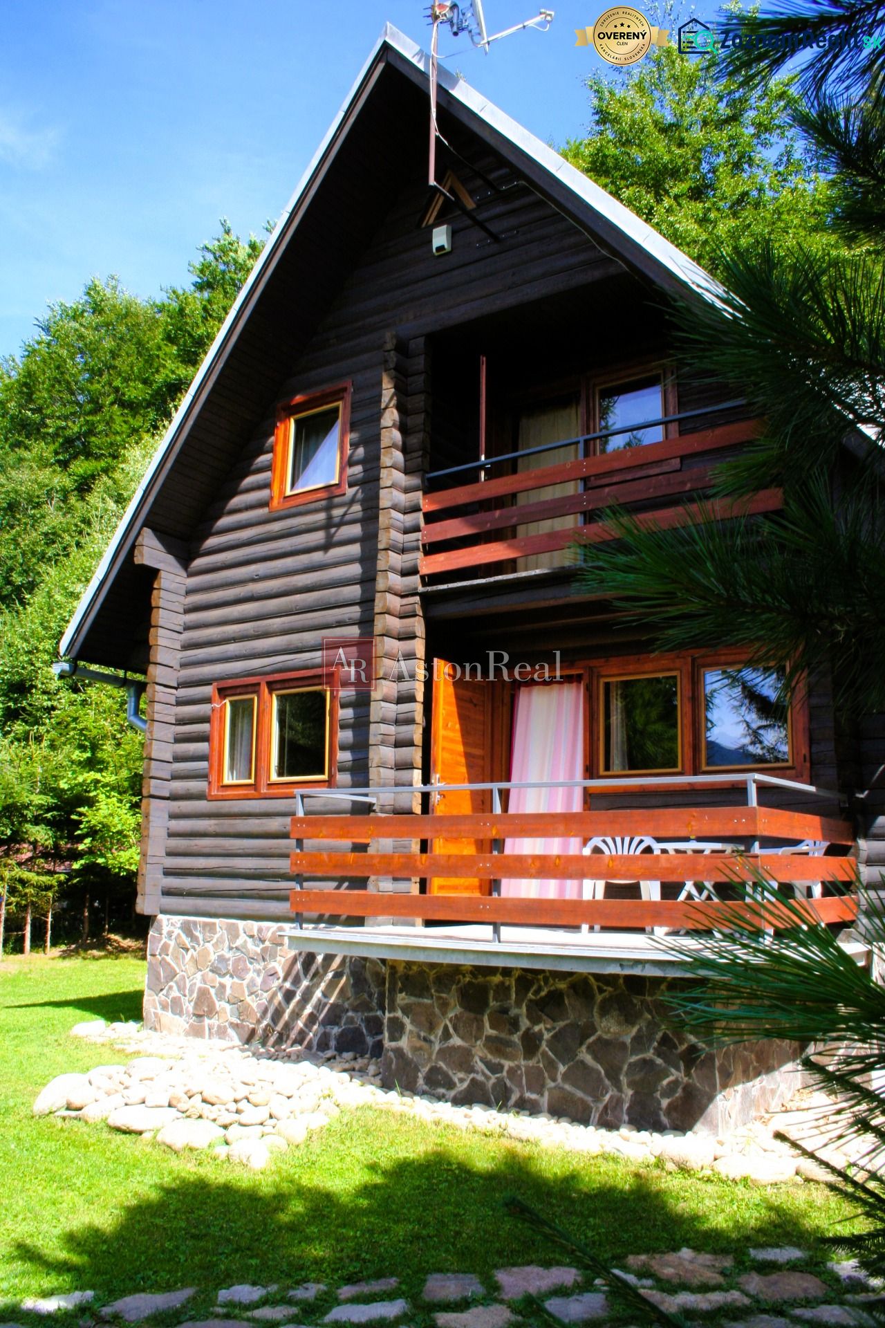 Chalupa Tále, okr.Brezno, pozemok 680m2,  - Drevená chata na Táľoch pri Brezne, obklopená zeleňou s kamenným soklom a terasou.