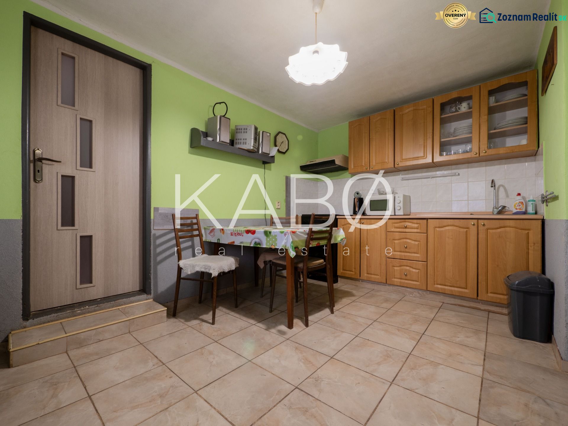3 izbový Rodinný dom v Cabaj-Čápore s pozemkom 1 053 m² - Kuchynský kútik v rodinnom dome s drevenými skrinkami a zelenými stenami.