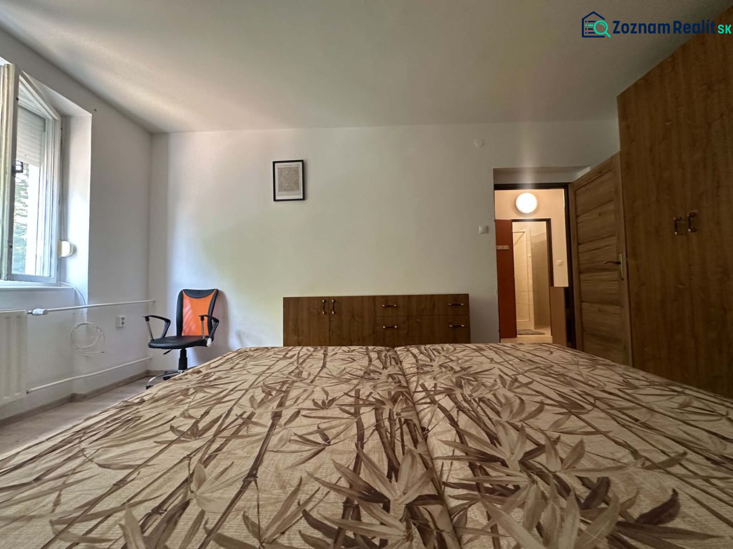 ☎️ 0918197701 Na prenájom  zariadený 1 izbový byt  na sídlisku západ n - Spálňa v 1-izbovom byte s posteľou, skriňou a stoličkou, podlaha s dreveným dekorom.