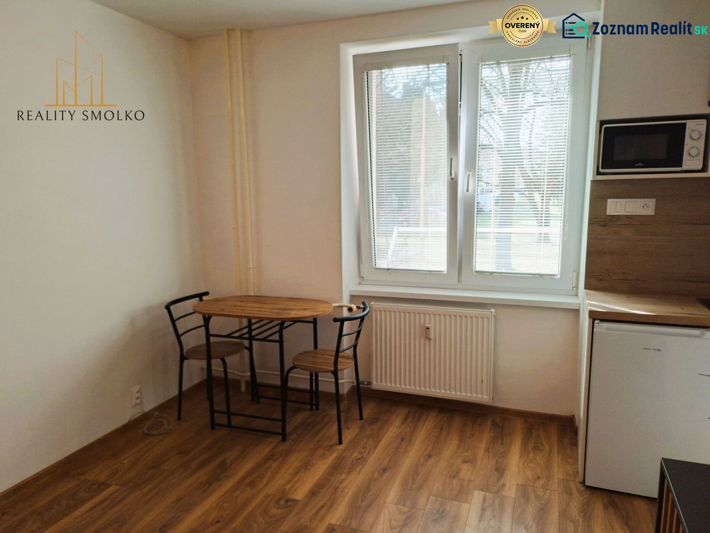 PRENÁJOM garsónky - 24 m², Humenné - Jedálenský stôl s dvoma stoličkami, podlaha s dreveným dekorom v Rekreačnom apartmáne.