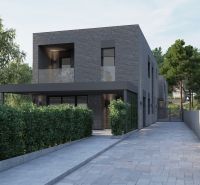 Stavebné pozemky s projektom 2 samostatných RD v obci Baška-časť Maša - Dvojpodlažný tehlový dom obklopený zeleňou, nachádzajúci sa na **pozemku** vhodnom pre **bývanie**.