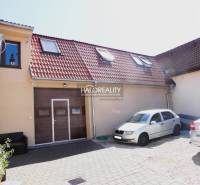 Predaj, rodinný dom Trnava, polyfunkčný objekt s veľ... - Rodinný dom v Trnave s hnedou garážou, sedlovou strechou a dvorom s lavičkou.