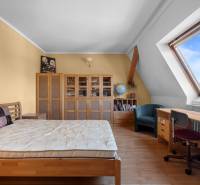 Priestranný 7-izbový dom na skok od centra – Senec - Izba v rodinnom dome so strešným oknom, posteľou, nábytkom a stolom.