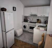 CHORVÁTSKO - Apartmány 1.rad od mora - SUKOŠAN, ZADAR - Kuchyňa v 1-izbovom byte s bielymi skrinkami, spotrebičmi a dreveným stolom.