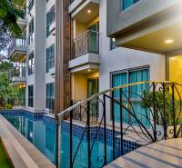 CITY GARDEN TROPICANA PATTAYA - Bazén a fasáda bytovej výstavby v Pattaye obklopené zeleňou.