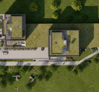 2i byt  A.3.1 - Bell Residence - Letecký pohľad na zelené strechy budov pri ulici Suchoňova, parkovisko a zeleň.