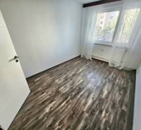 PRENÁJOM 3 IZBOVÝ BYT / 70 M2 /VEĽKOMETRÁŽNY/DUBNIČKA /LOGGIA - Prázdna izba s laminátovou podlahou a veľkým oknom v 3-izbovom byte.