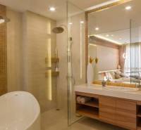 2 IZBOVÝ APARTMÁN (2 SPÁLNE + 1 OBÝV. IZBA) CITY GARDEN TOWER PATTAYA - Kúpeľňa v 3-izbovom byte s vaňou, sprchou a veľkým zrkadlom. Elegantné osvetlenie dopĺňa priestor.