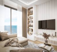 2 IZBOVÝ APARTMÁN (2 SPÁLNE + 1 OBÝV. IZBA) SEASPIRE JOMTIEN PATTAYA - Obývačka v 3-izbovom byte s výhľadom na more, pohodlná sedačka, televízor na stene.