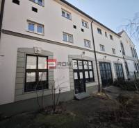 EXKLUZÍVNA INVESTÍCIA: MULTIFUNKČNÁ BUDOVA NA PREDAJ, TRNAVA - Na ulici Ľ. Podjavorinskej sa nachádza budova s veľkými oknami a historickými detailmi.