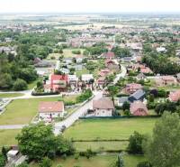 Nádherný pozemok 632 m2 s výhľadom na Alpy Marianka - Letecký pohľad na domy a zeleň v obci Marianka na ulici Na Tálkoch. Pozemky - bývanie.