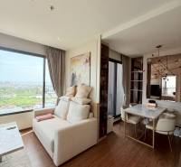 2 SPÁLŇOVÝ APARTMÁN ONCE PATTAYA - Obývacia miestnosť v 3-izbovom byte, svetlé steny, veľké okno, jedálenský stôl.