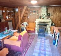 Murovaná záhradná chata, 361 m2, Zvolen - Sekier - Drevený interiér chaty s krbom, posedením a kuchynským kútom.