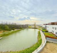 Predaj 2-izb. bytu so záhradou a terasou, Nová Tehelňa, Senec (A1101) - Výhľad z 2-izbového bytu na ulici Vtáčia na jazero a moderné budovy.