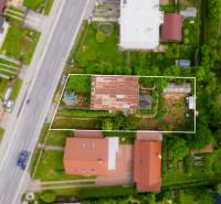 Na predaj Rodinný dom Drietoma – pozemok 745 m2  - Letecký pohľad na pozemok s rodinným domom v Drietome, obklopený ďalšími domami a záhradami.