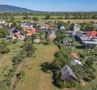 PREDAJ, Pozemok s rodinným domom Sečovce, okres Trebišov - Letecký pohľad na obecné pozemky na bývanie v Sečovciach obklopené zeleňou a domami.