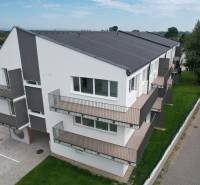 Nadštandardný 3 izbový byt v novostavbe v obci Zálesie - Bytový dom na ulici Muškátová s balkónmi, zeleným trávnikom a parkovacími miestami.