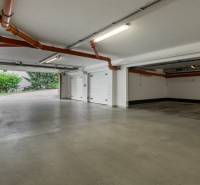 Veľmi pekný 4i byt 110m2, s klimatizáciou, 2x balkón a dvojgaráž - Parkovací priestor v 4-izbovom byte s otvorenými garážovými vratami a potrubím na stropoch.