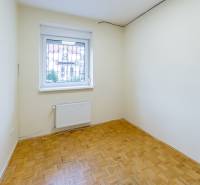 Príjemný dvojpodlažný RD 193 m2, klimatizácia, nezariadený, s garážou - Izba s parketami a oknom v rodinnom dome, svetlé steny a radiátor.