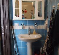 Predaj bytu 3-izbového (3+kk) s rozlohou 65 m² a terasou 10 m², Scalea - Kúpeľňa v 3-izbovom byte s modrými obkladačkami, umývadlom a nástennou skrinkou.