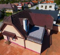 6-izbový rodinný dom s pozemkom 2218m2  | Horňany - Rodinný dom v Horňanoch s červenohnedou strechou a terasou, okolie z dlažby.