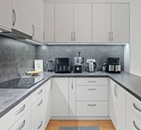 Slnečný 3i byt pod lesom, 74m2, balkón, parking, pivnica, Hainburg - Kuchyňa v 3-izbovom byte s bielymi skrinkami a tmavosivými pracovnými doskami.