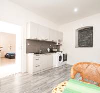 Veľký 6i RD, SUPER ivestičná príležitosť, Tr. Teplá - Kuchyňa v rodinnom dome na ulici M. R. Štefánika s práčkou a drevom na podlahe.