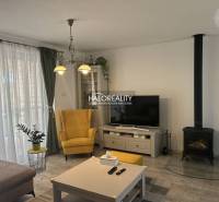 REZERVOVANÉ - Predaj, rodinný dom Malinová - NOVOSTA... - Obývacia izba v rodinnom dome s krbom, žltým kreslom a televízorom.