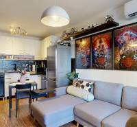 3D, predaj 3 izb. byt, balkón, loggia, klíma, Agátová ul., Dúbravka - Obývačka v 3-izbovom byte s kuchyňou, sedačka, plagáty, dekorácie, drevená podlaha.