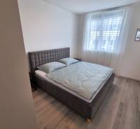 PRENÁJOM - 3 izbový byt Nitra – RIVIERA NITRA, Piesková ulica - Spálňa so sivou posteľou a svetlým nábytkom v 3-izbovom byte.