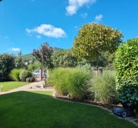 PREDAJ - Exkluzívny rodinný dom - Nitra, Zobor - Záhrada rodinného domu v Nitre s výhľadom na zeleň a vežu na kopci.