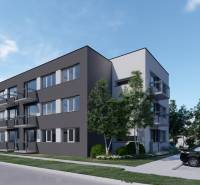 Pozemok s rozostavanou stavbou pre 12 bytov pri Senici - Trojposchodová budova s balkónmi a parkovacími miestami, obklopená zeleňou a stromami.