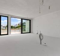 Nadštandardná 4- izbová terasová vila na Kolibe s krásnym výhľadom - Priestranný interiér na ulici Svätovavrinecká, veľké okná, výhľad, rodinný dom v pozadí.