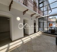 Prenájom obchodných priestorov, 268m2, Letná ulica, Spišská Nová Ves - Interiér obchodných priestorov s kamennou podlahou a presklenou stenou; svetlé miestnosti.