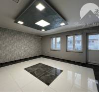 Vám ponúka na PREDAJ kompletne zrekonštruovaný  - Miestnosť v rodinnom dome s dlažbou, vzorovanou tapetou a zníženým stropom so svietidlami.